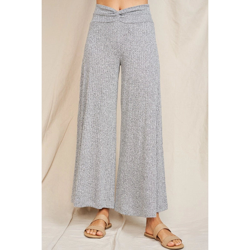 A pair of rib knit soft comfy heather grey drapey wide leg flare pants with a waistband that is twisted in the front center.