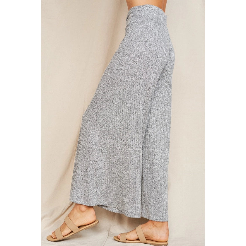 Side+back view of a pair of rib knit soft comfy heather grey drapey wide leg pants.