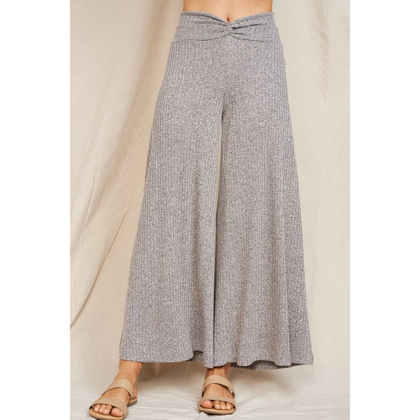 A pair of rib knit soft comfy heather grey drapey wide leg flare pants with a waistband that is twisted in the front center.