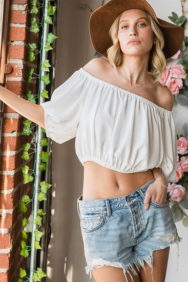 model wearing white off shoulder short puff sleeve loose summer crop top